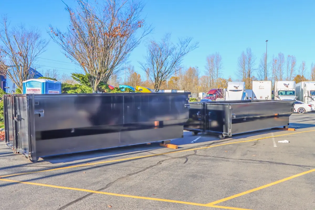 Professional dumpster rental service with roll-off container on residential driveway in West Deer